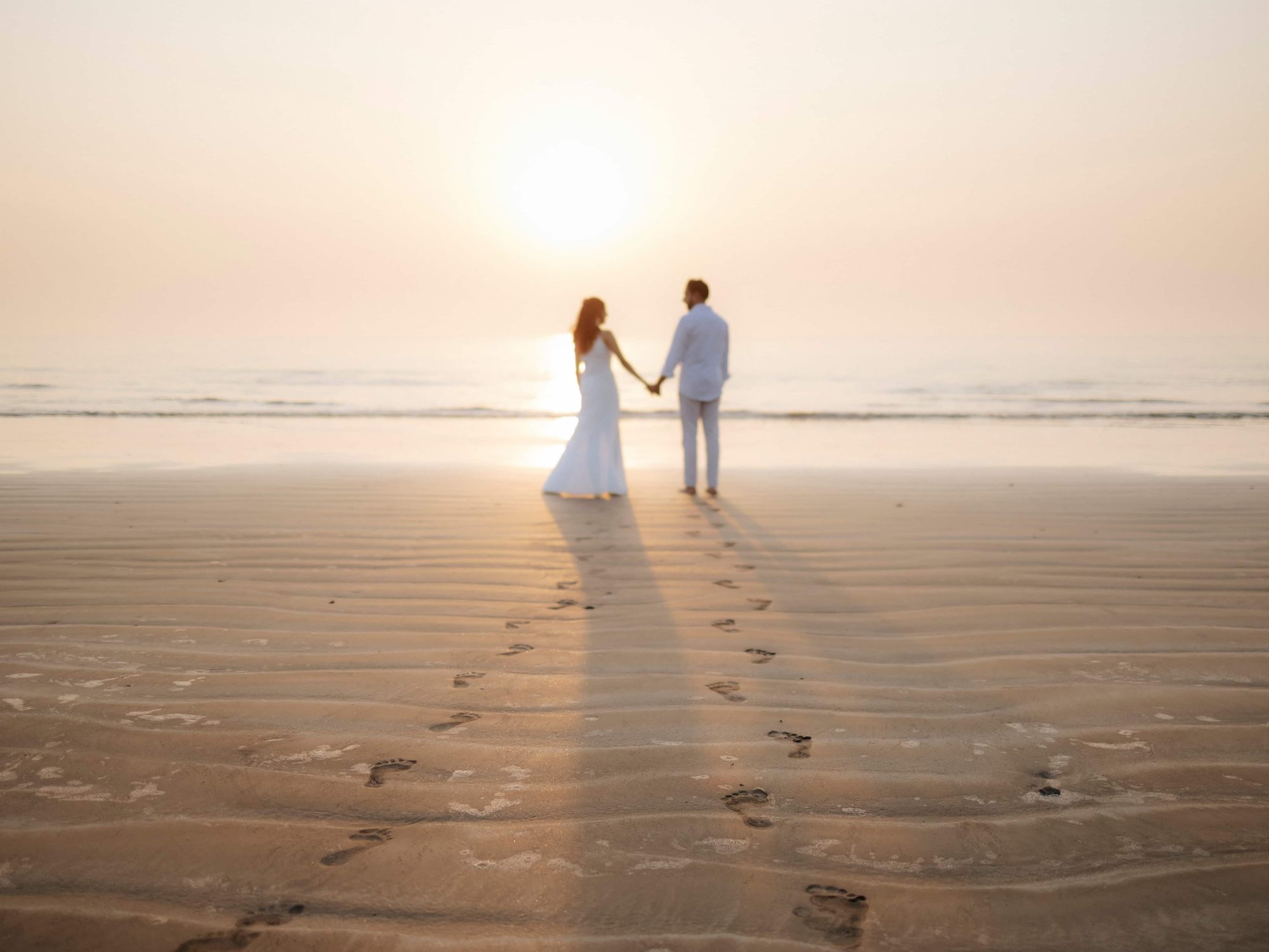 Couple on the shore at sunset, Mumbai
