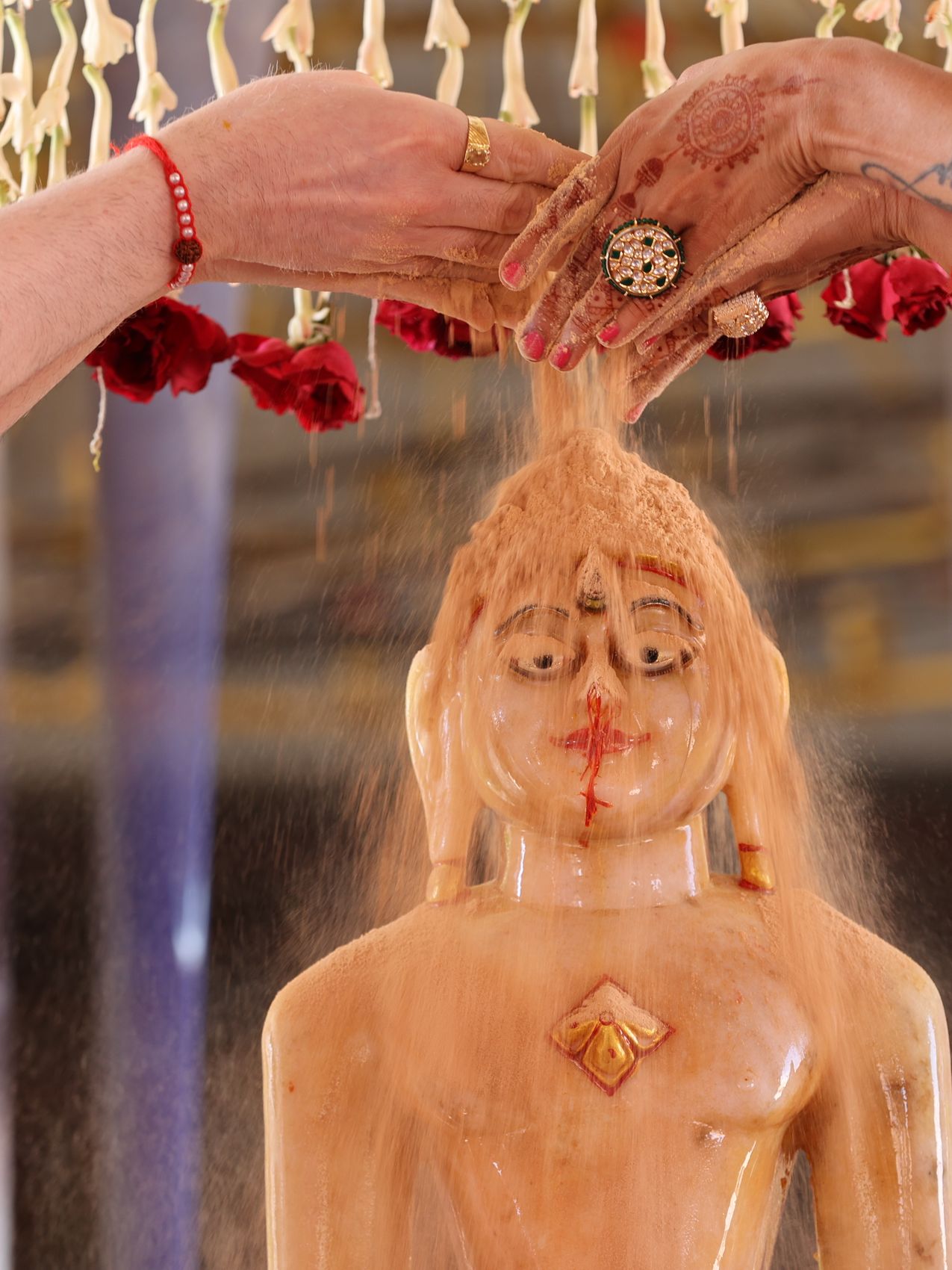 Abhishek during a Jain puja, water poured over the idol