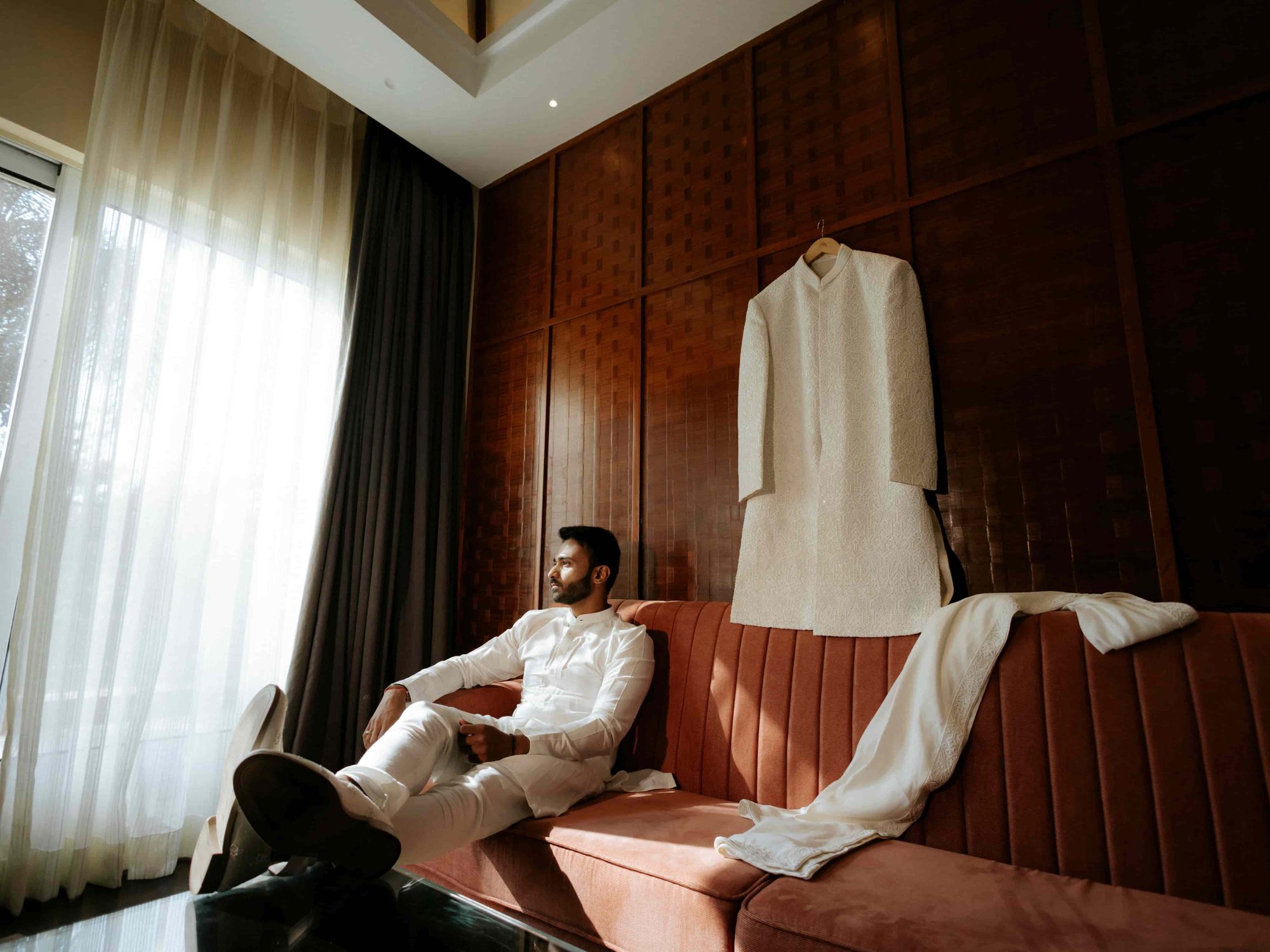 Sherwani laid out as the groom waits, getting-ready detail